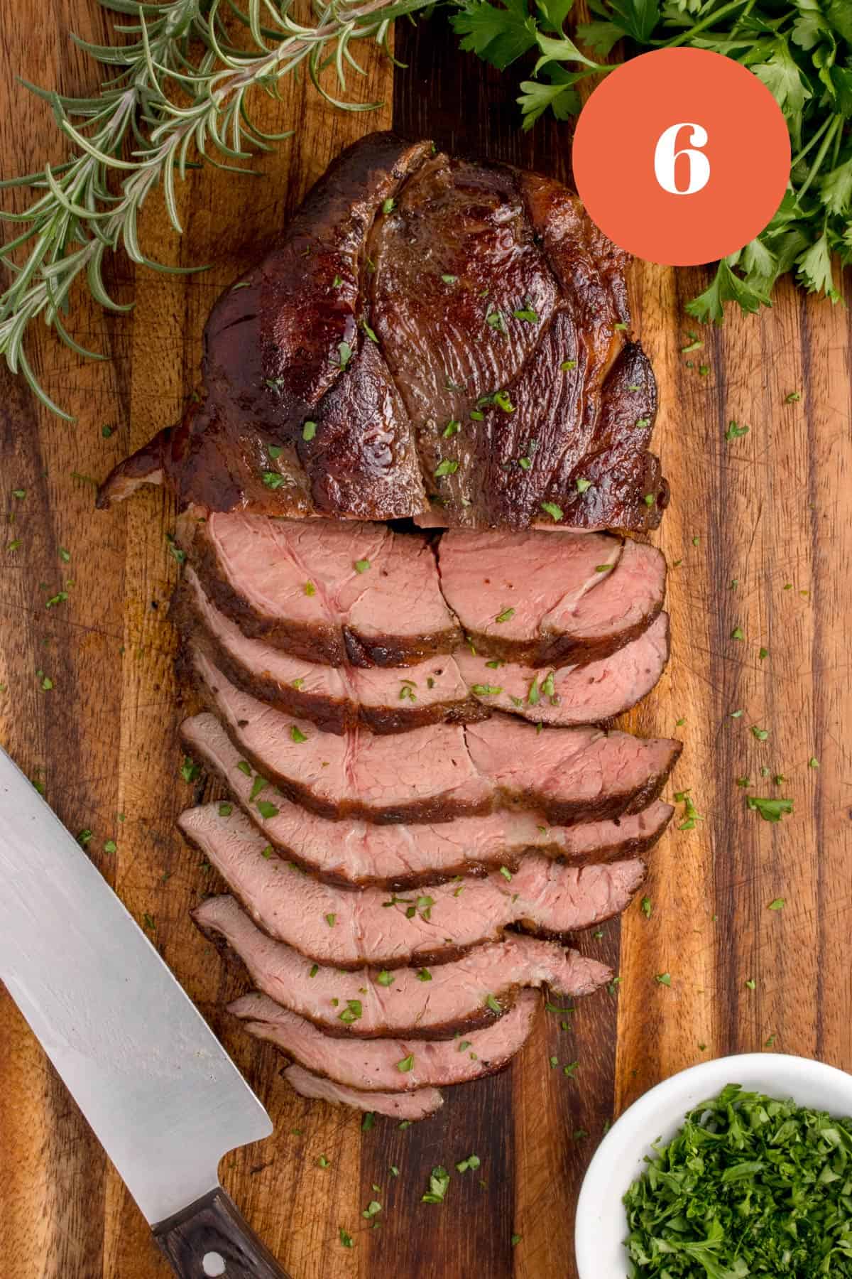 A sliced cut of beef done medium-rare.