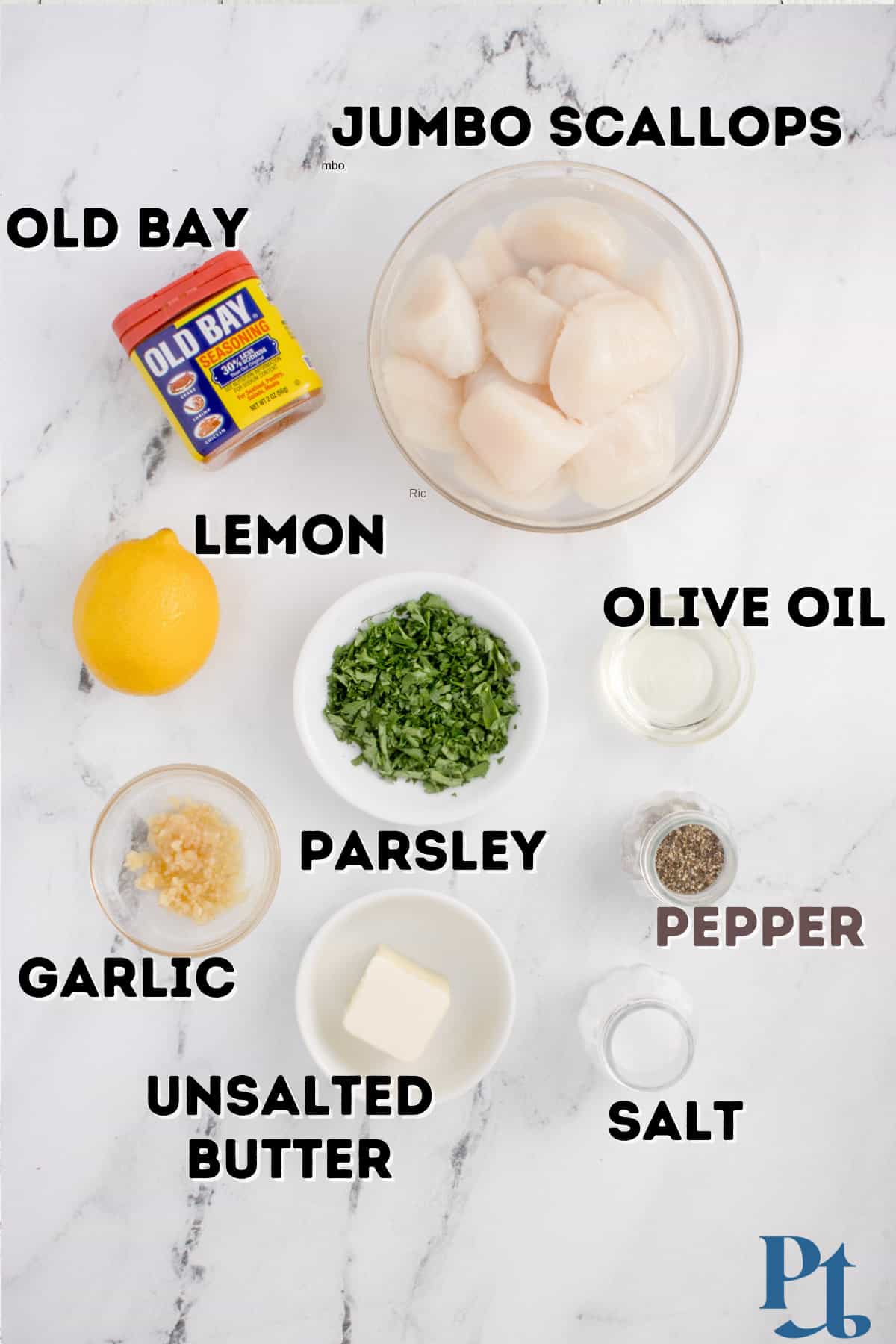 Some jumbo scallops, a lemon, and other ingredients.