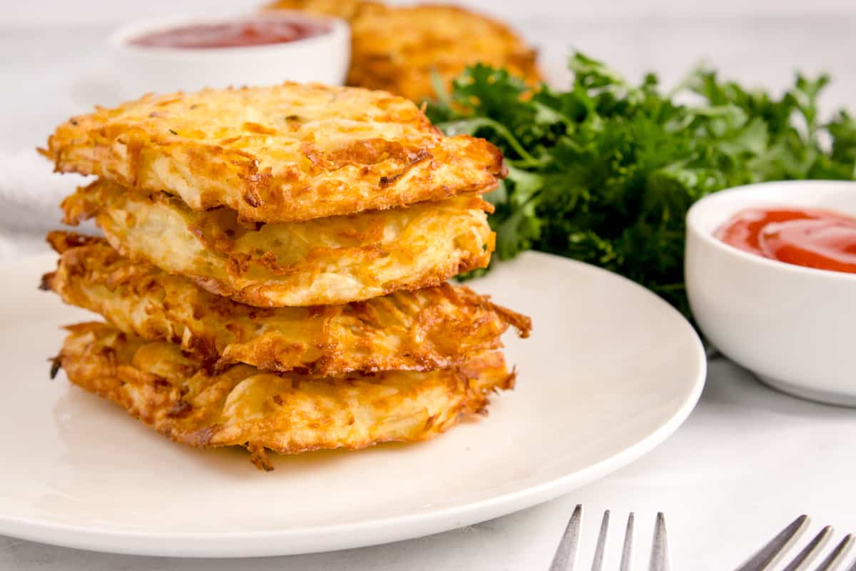 A stack of hash browns on a plate.