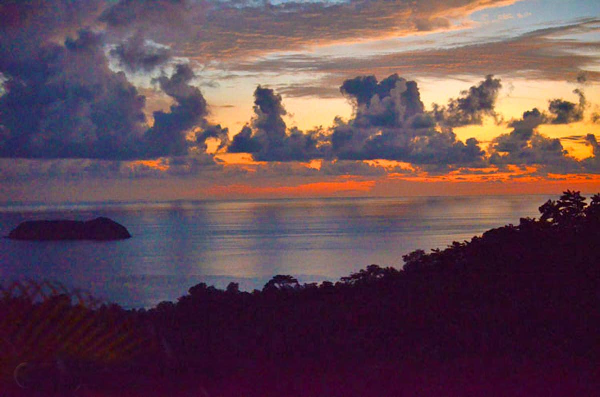 A tropical sunset on the water.