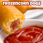 Dipping a corn dog into a dish of ketchup.