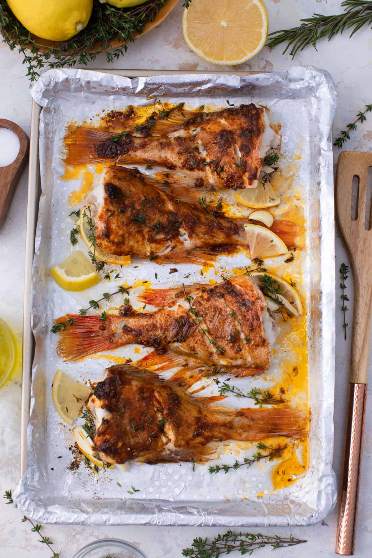 A baking tray of baked fish.