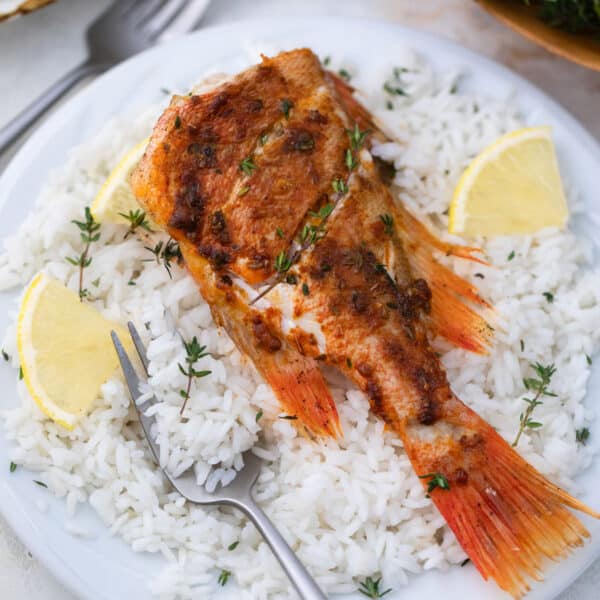 A piece of baked fish on white rice.