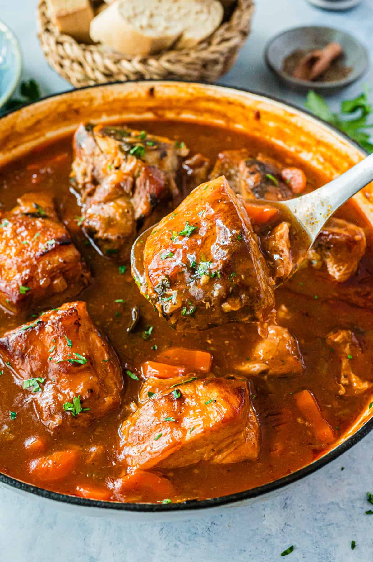 A pot of cooked meat in a red sauce.