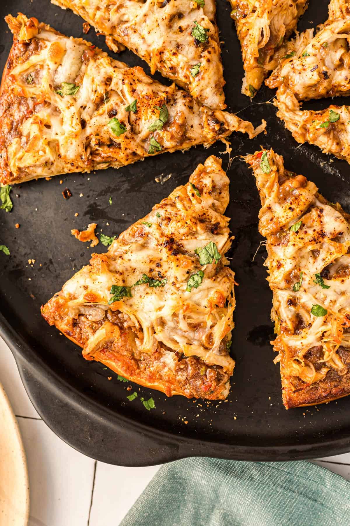 Overhead view of some pizza on a pan.