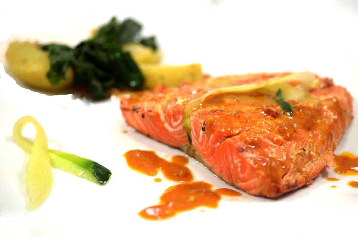 A plate of salmon with blitva.