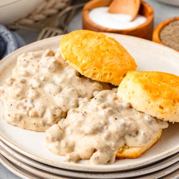 A plate of sausage gravy and biscuits.