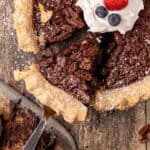 A slice of chocolate bourbon pecan pie on a spatula.