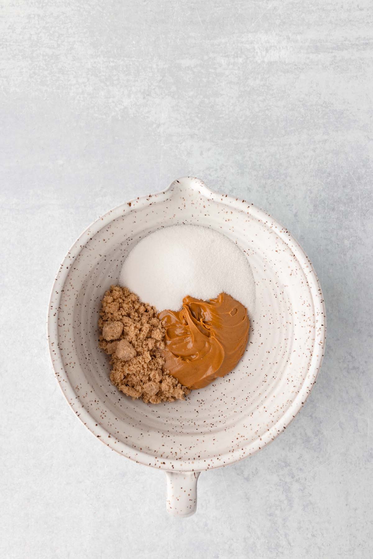 Some peanut butter and sugar in a bowl.