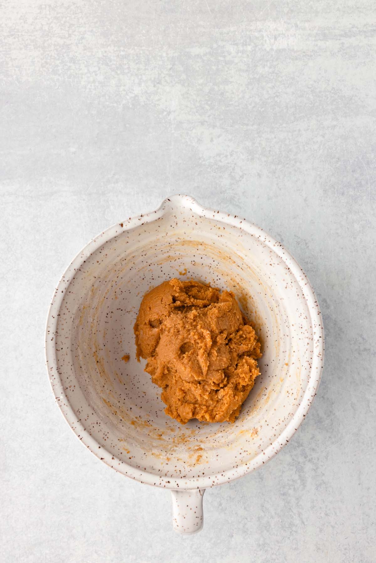 A mixing bowl of peanut butter cookie dough.