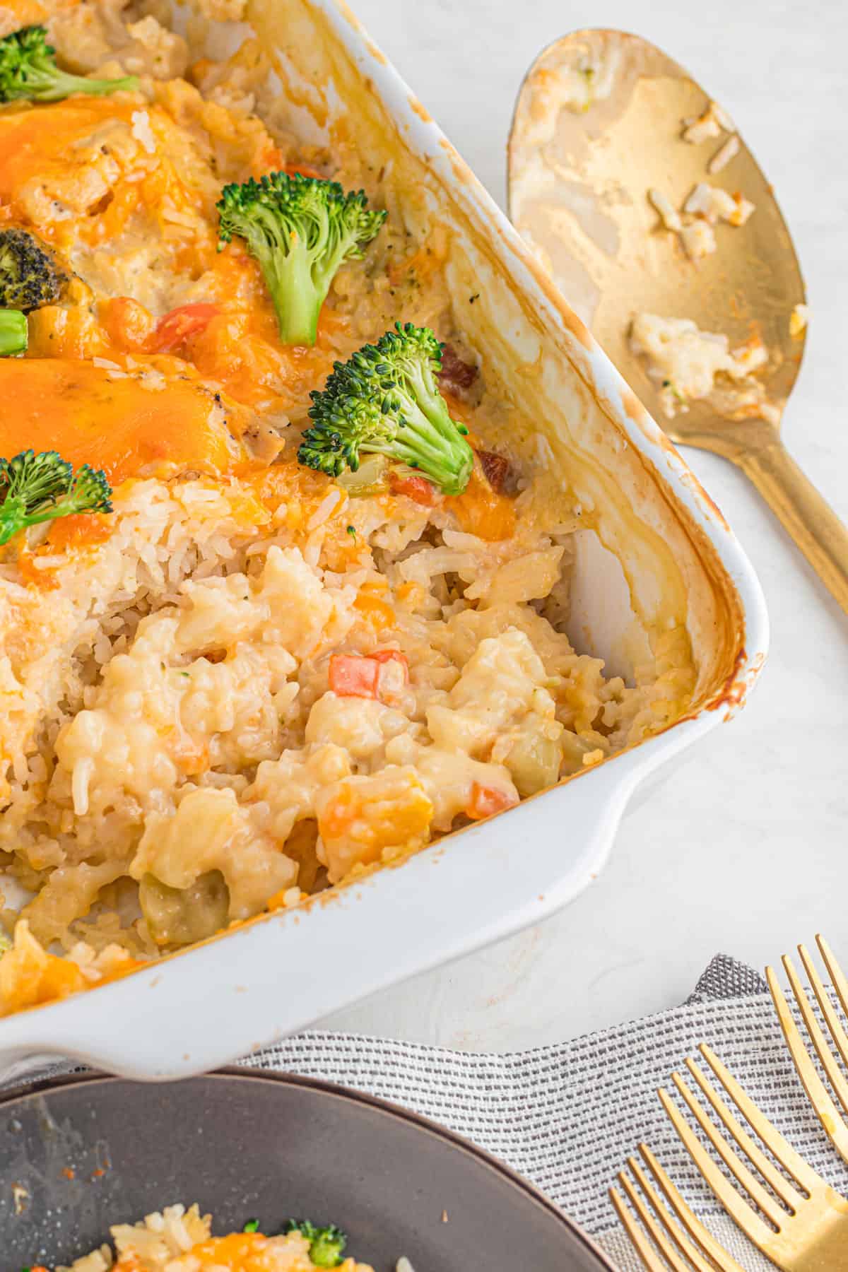 A casserole dish with chicken and rice and broccoli.