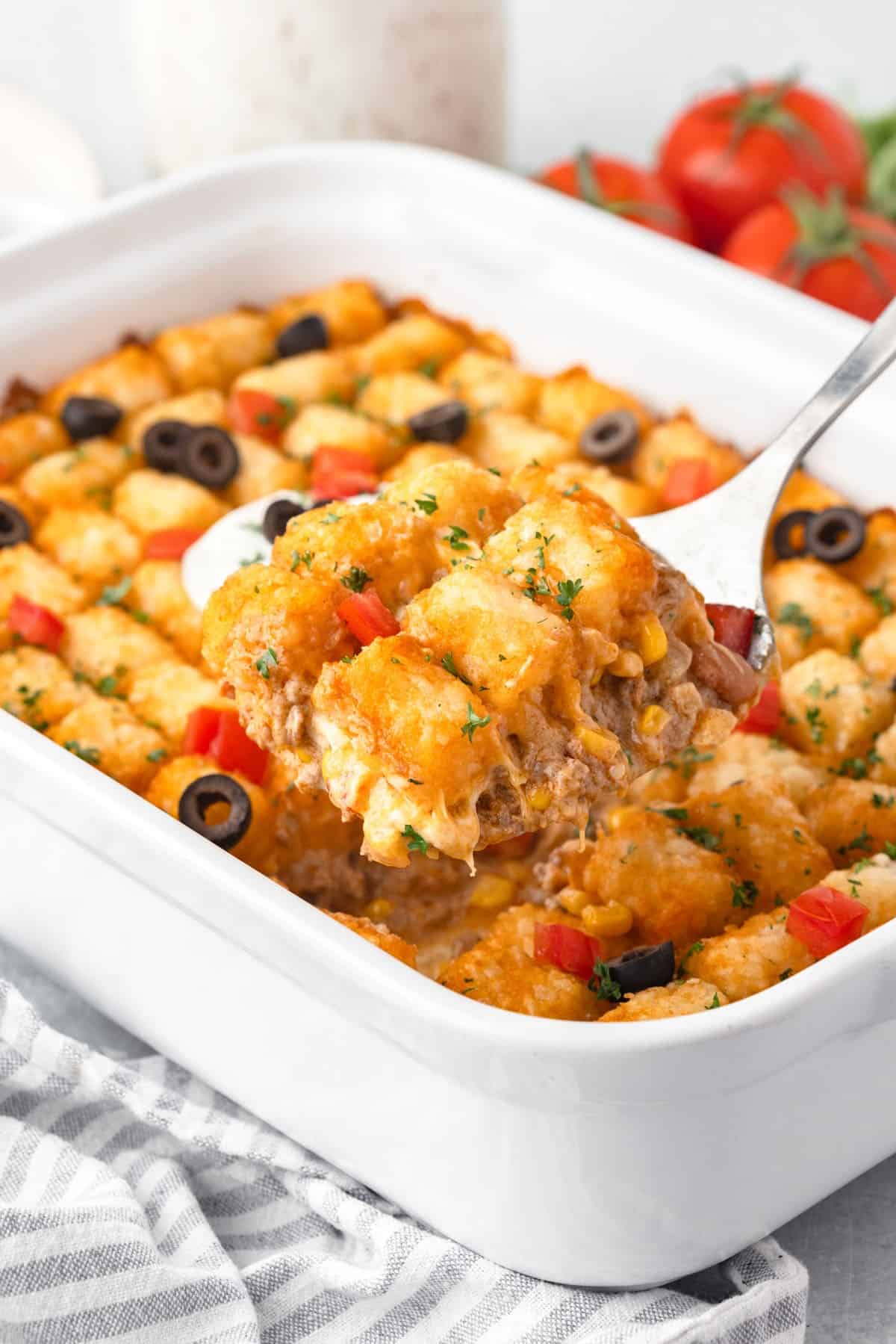 A tater tot casserole in a white badking dish.