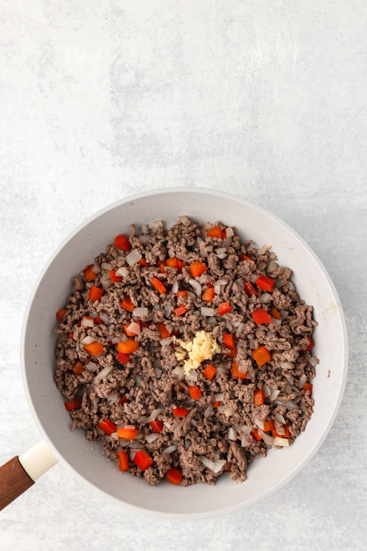 Some browned ground beef in a skillet.