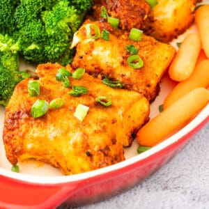 A piece of golden air fryer cod in a baking dish.