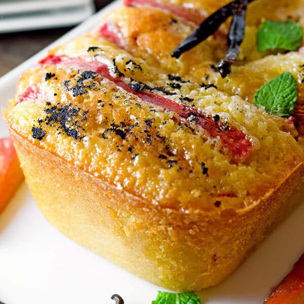 A pound cake with rhubarb on top.