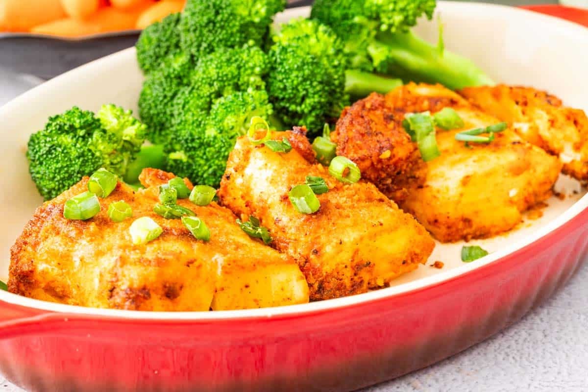 A baking dish of air fryer cod with broccoli.