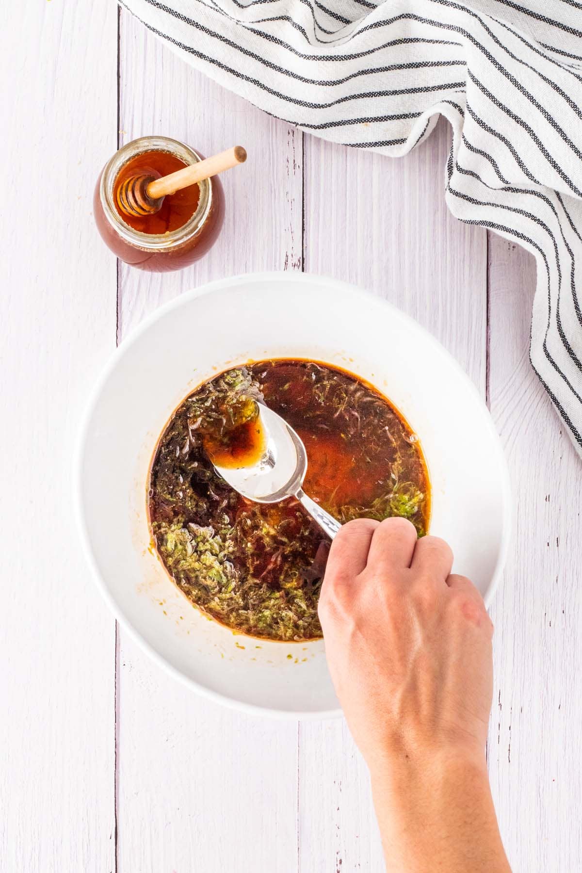 Mixing soy sauce with olive oil and lime juice and honey.