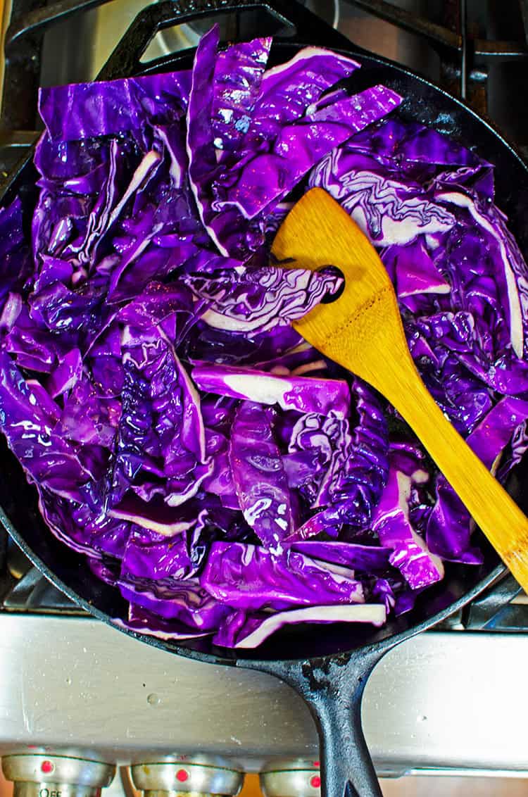 Making fried purple cabbage in a cast iron skillet.