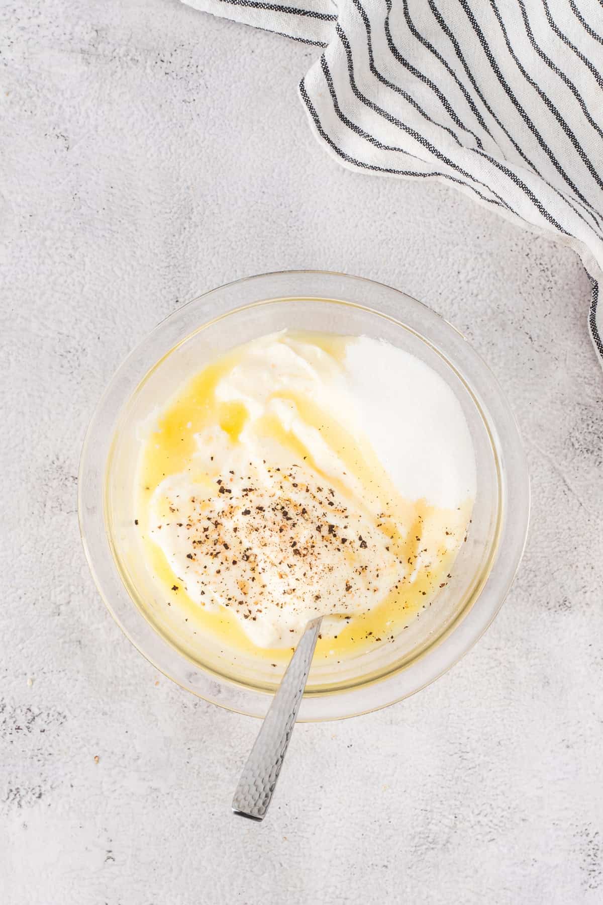 Mixing lemon juice, seasoning, and mayonnaise in mixing bowl.