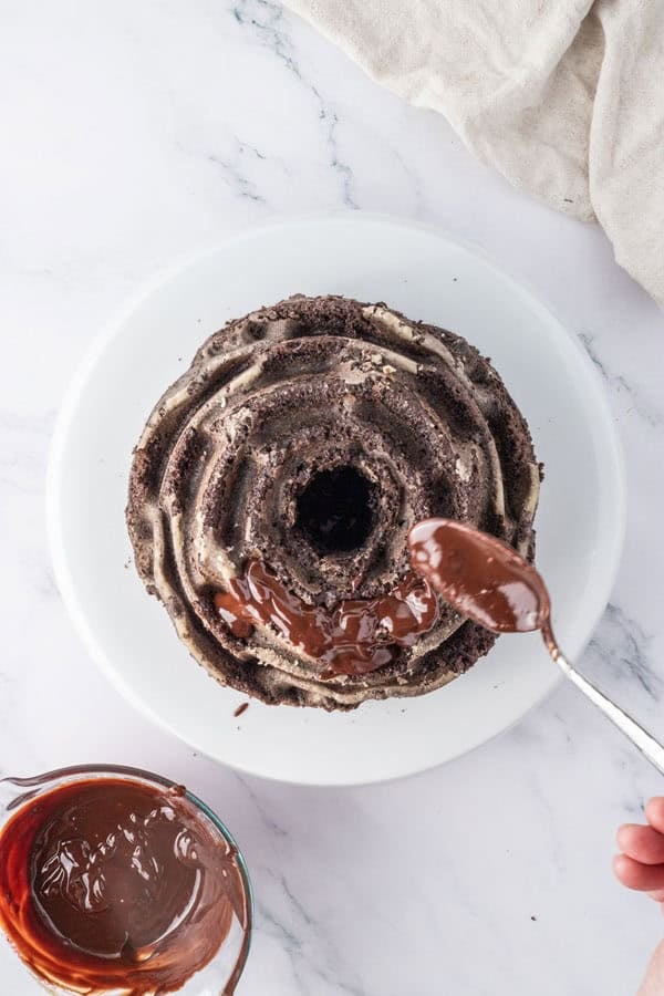 Drizzling chocolate ganache over a chocolate Oreo Bundt cake.