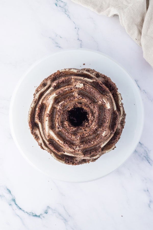 A chocolate Oreo Bundt cake cooling on a wire rack.