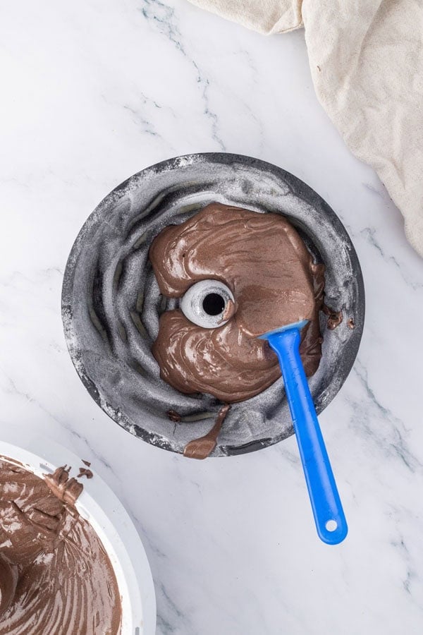 Spreading cake batter into a Bundt pan.