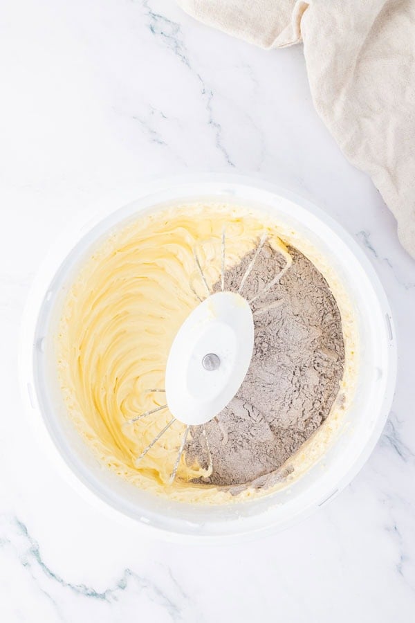 A mixing bowl with cake batter with wet and dry ingredients.