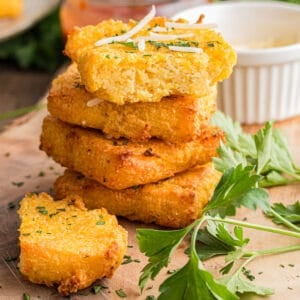 A stack of golden homemade air fryer polenta squares.